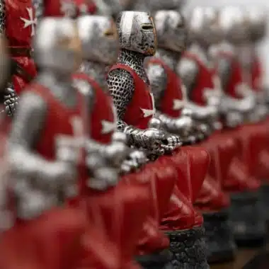 Pions rouges du jeu « Templier II » alignés, détail des armures argentées