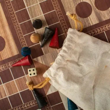 Detal pionków Ludo i kostki na planszy z intarsją