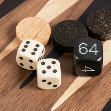 Backgammon: okrągłe pionki, białe kostki i kostka doublera z oznaczeniem 64 na planszy