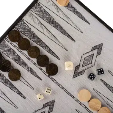 Detal planszy do backgammona z ciemnymi i jasnymi drewnianymi pionkami oraz kostkami